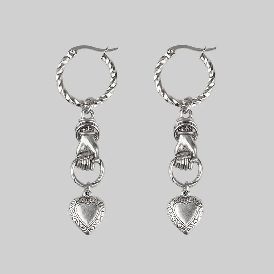 ALL OF ME. Hand Grasping Heart Earrings - Silver